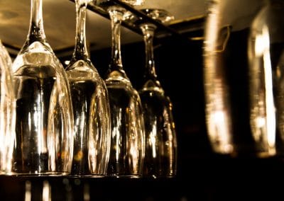 Commercial photography or winery bar with glasses hanging for serving